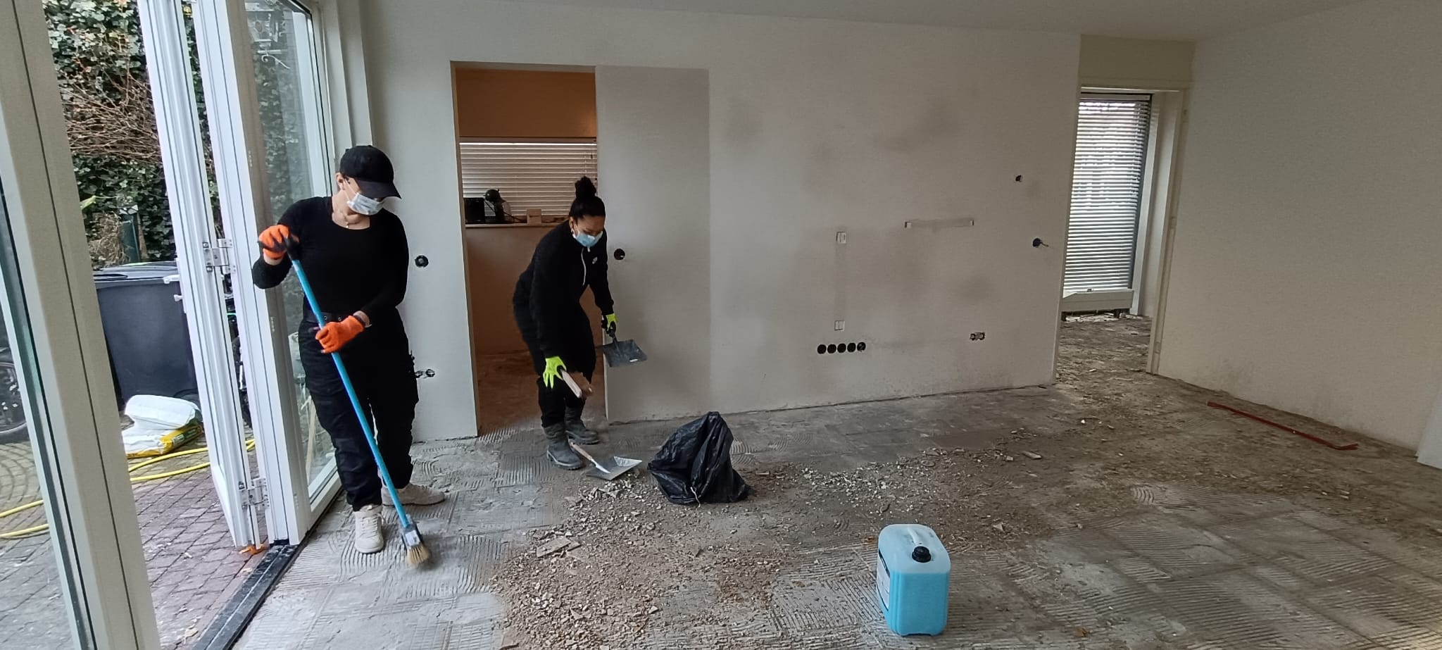 J.C. Multiservices team carrying out post-construction cleaning in a renovated room